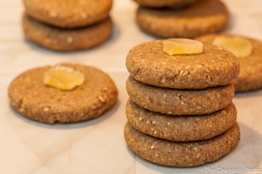 stack of four raw ginger bites biscuits with stacks of one or two more biscuits in background